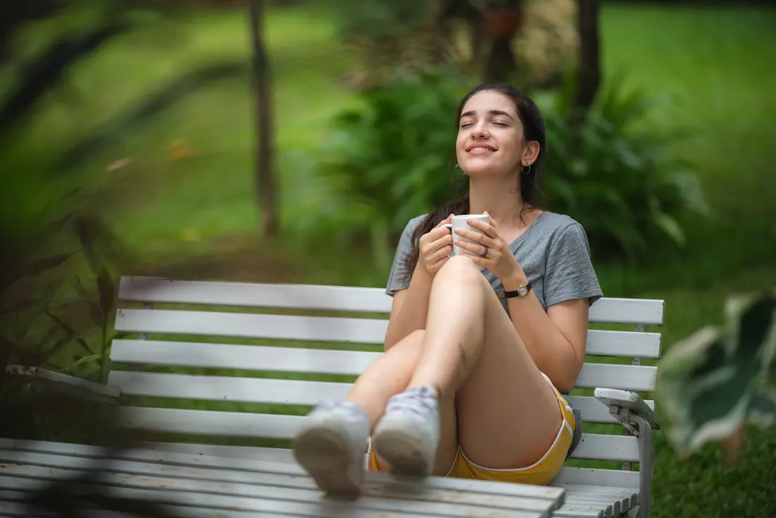 Woman relaxing outside with a cup