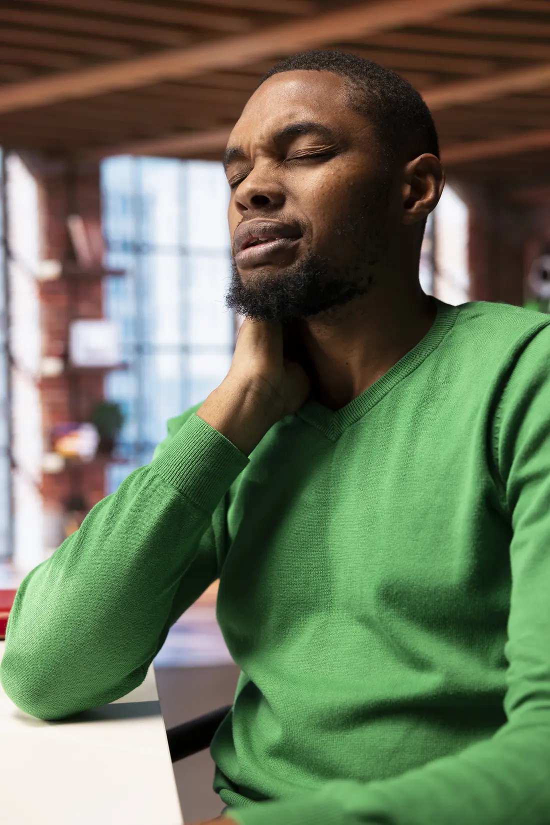 Person stretching neck during home office